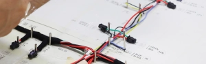 FPIC engineer reviewing a custom wire harness prototype