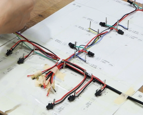 Wire harness assembly fixtures locating connectors and guiding branches on an assembly board